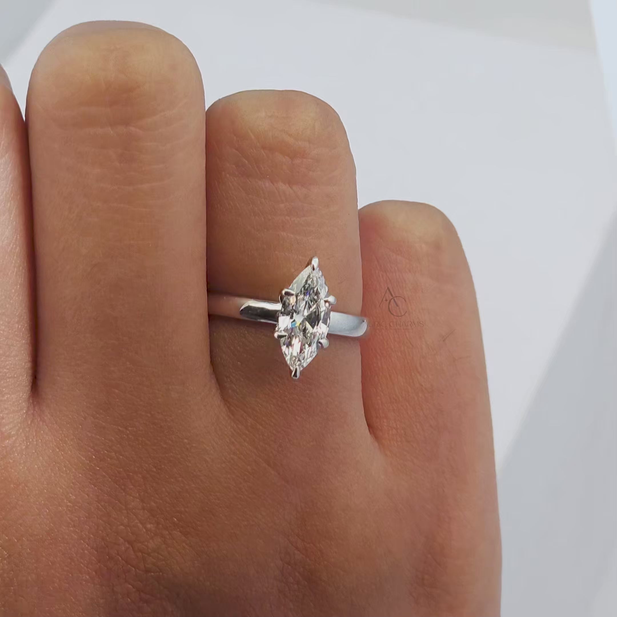 360-degree rotating view of a marquise-cut diamond solitaire ring with a polished band, displaying its sparkle and elegant craftsmanship.