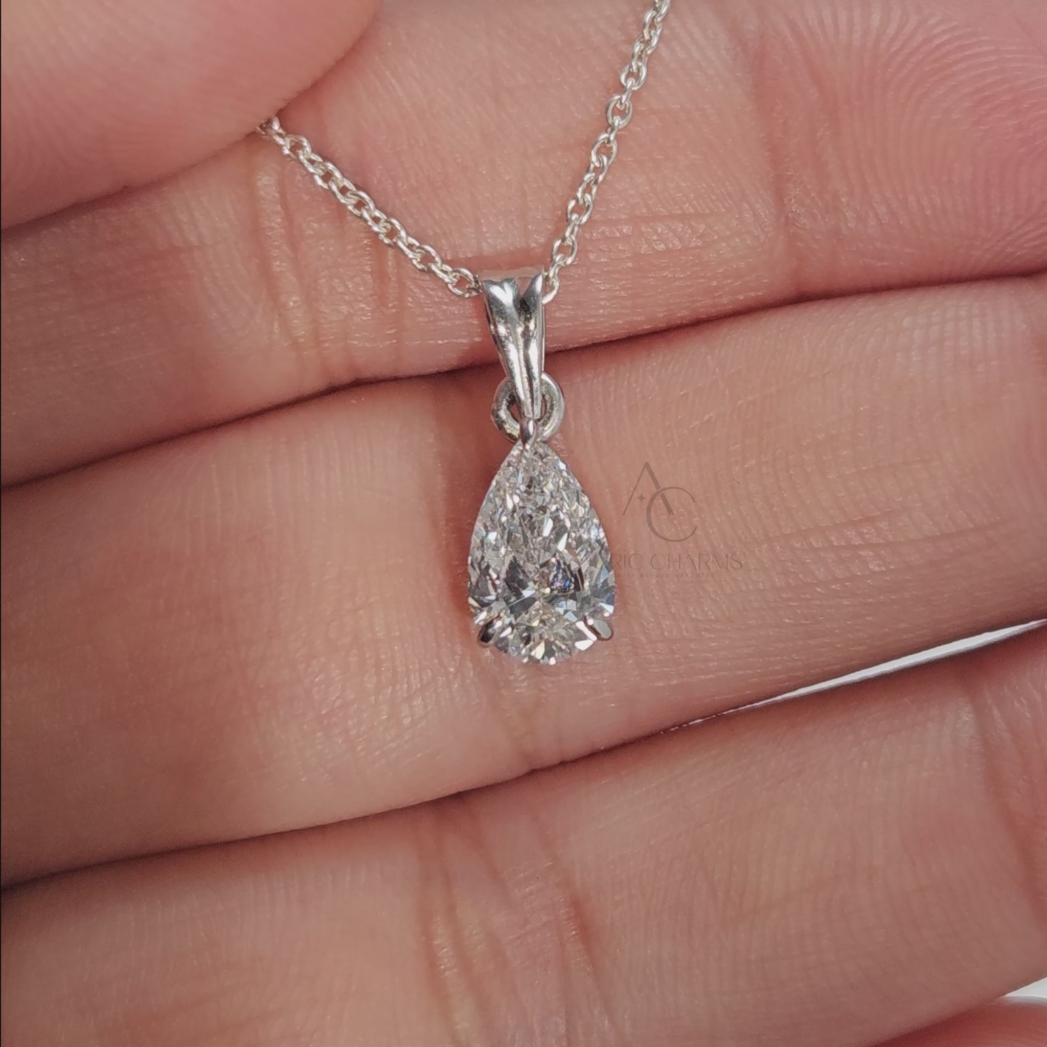 Teardrop lab-grown diamond pendant on a white gold chain, rotating to show sparkle and detail.