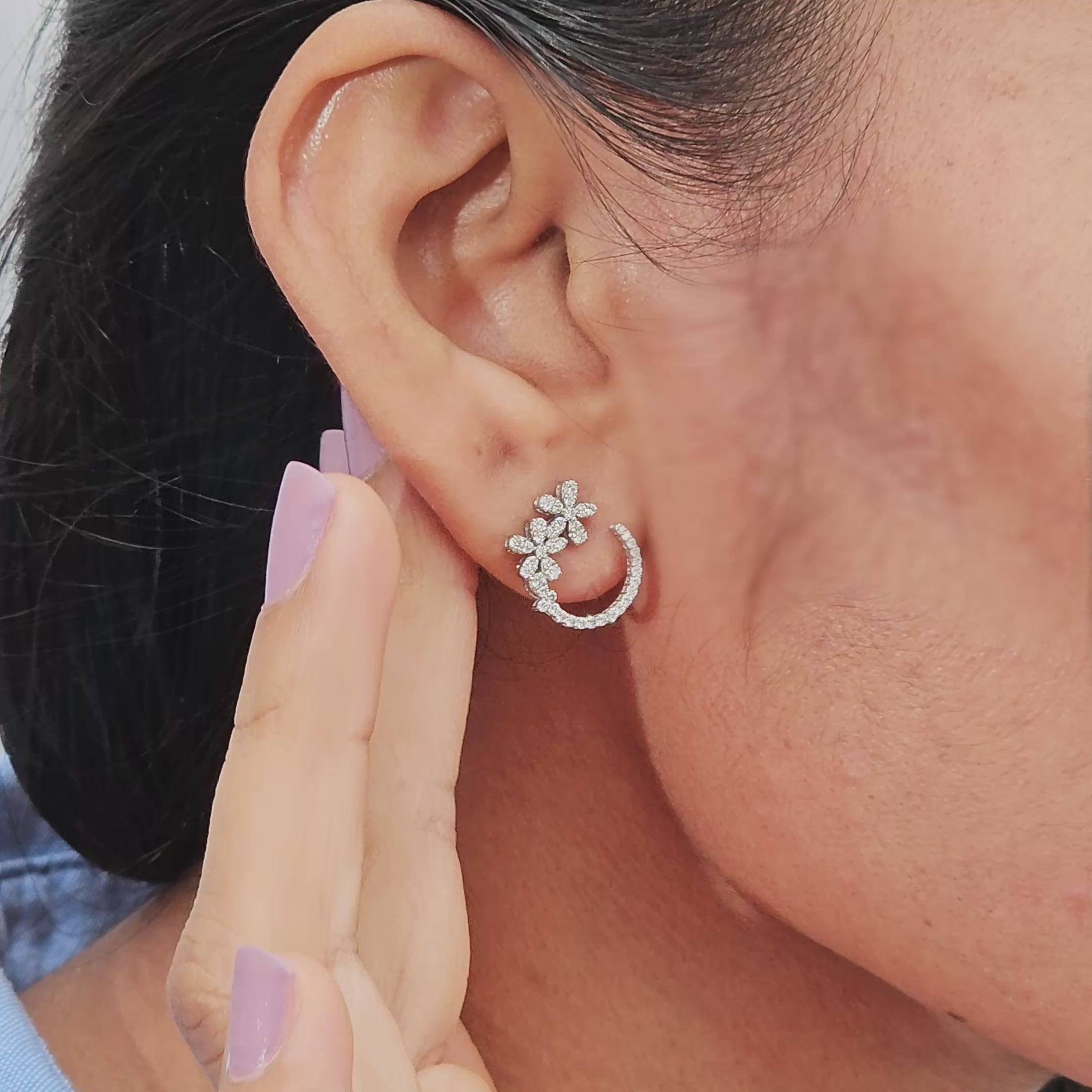 A woman showcases Rosalie Floral Lab-Grown Diamond Hoop Earrings, featuring delicate floral designs in ethical luxury.