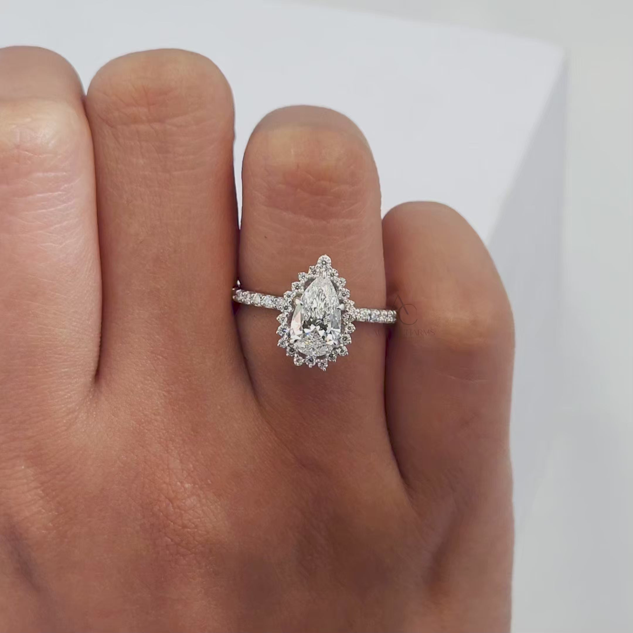360-degree view of pear-shaped halo lab-grown diamond engagement ring with pave band, highlighting its sparkle