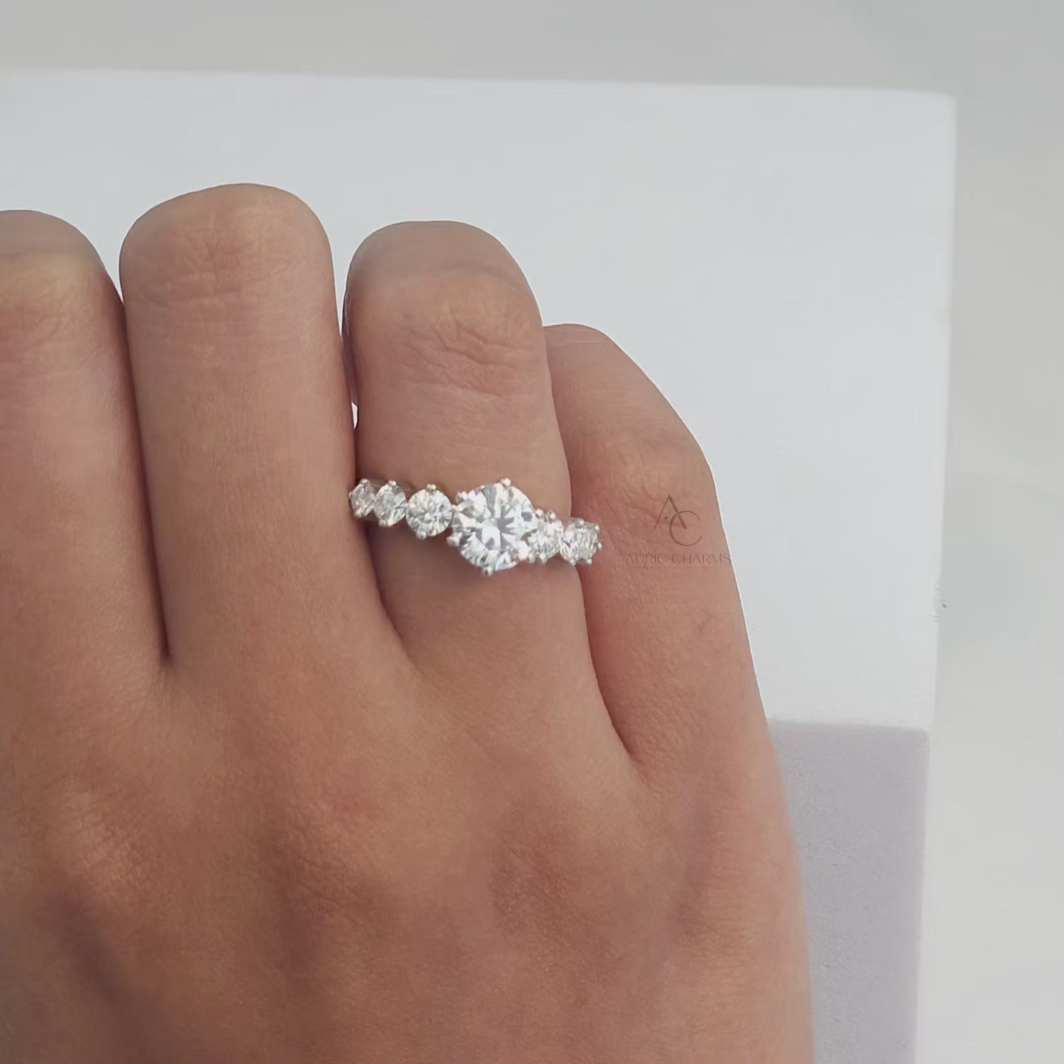 360° view of a stunning diamond ring with brilliant round-cut stones on a polished band.