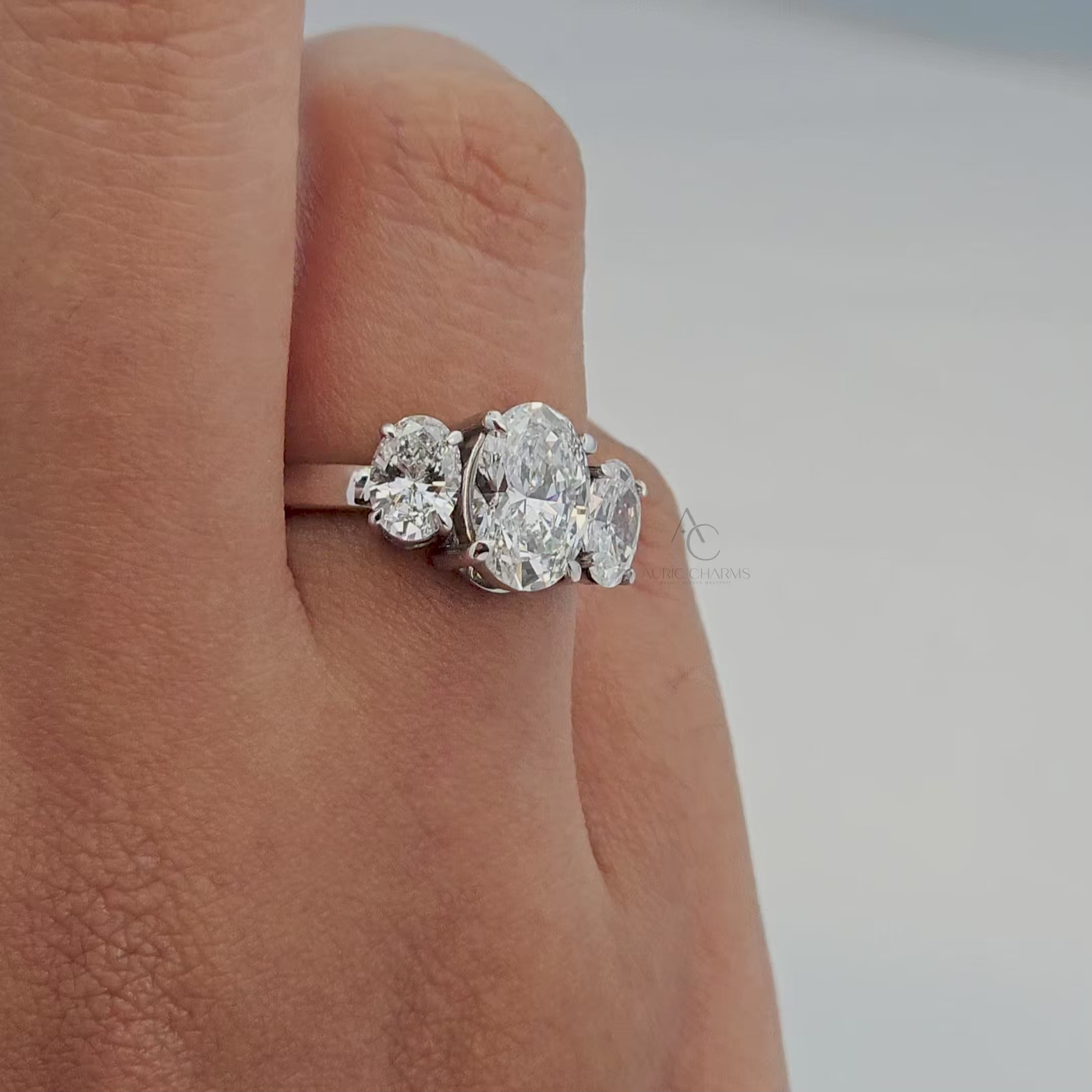 360° view of three-stone oval lab-grown diamond ring showcasing brilliance and intricate design.