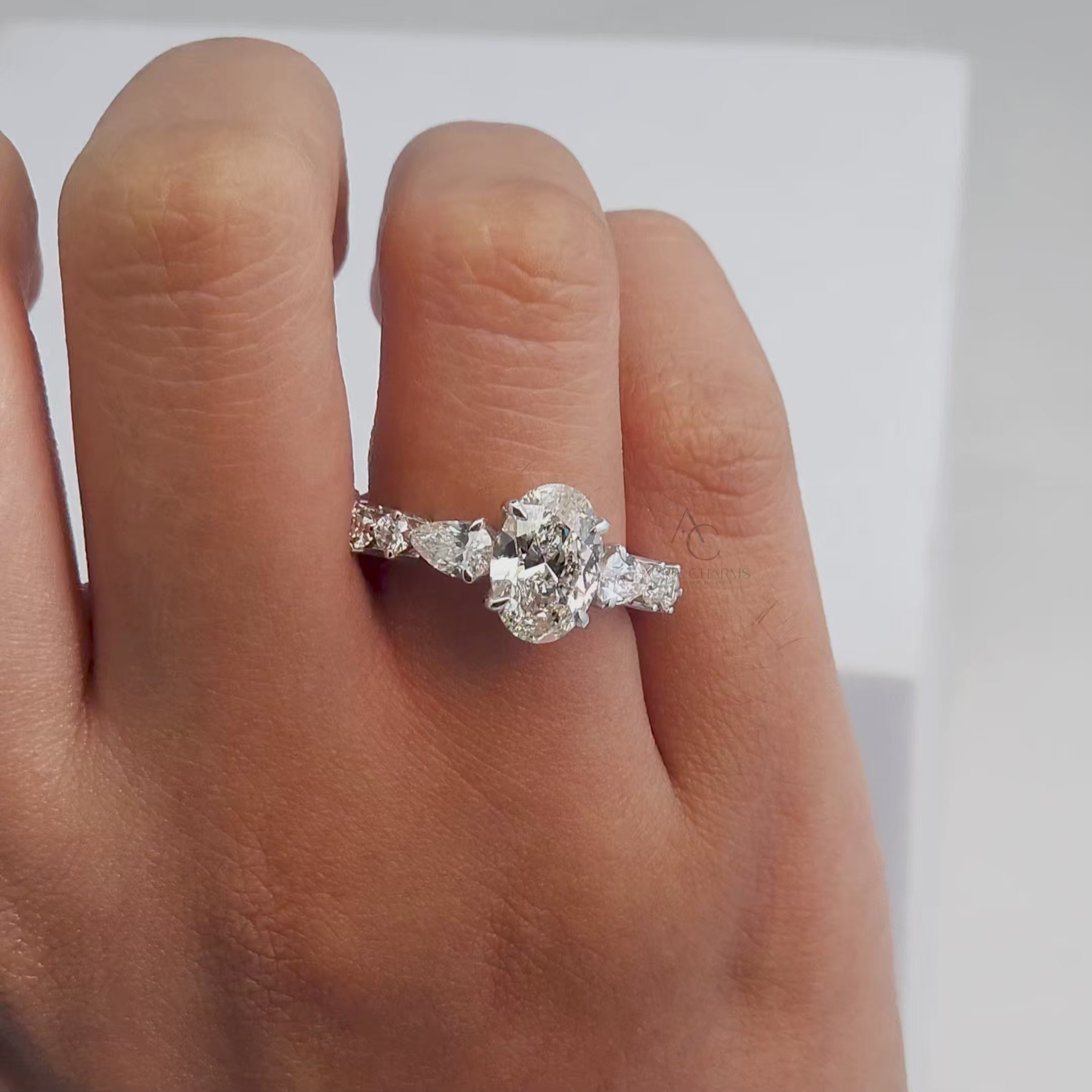 60-degree view of a lab-grown oval diamond engagement ring with sparkling side stones in a platinum band.