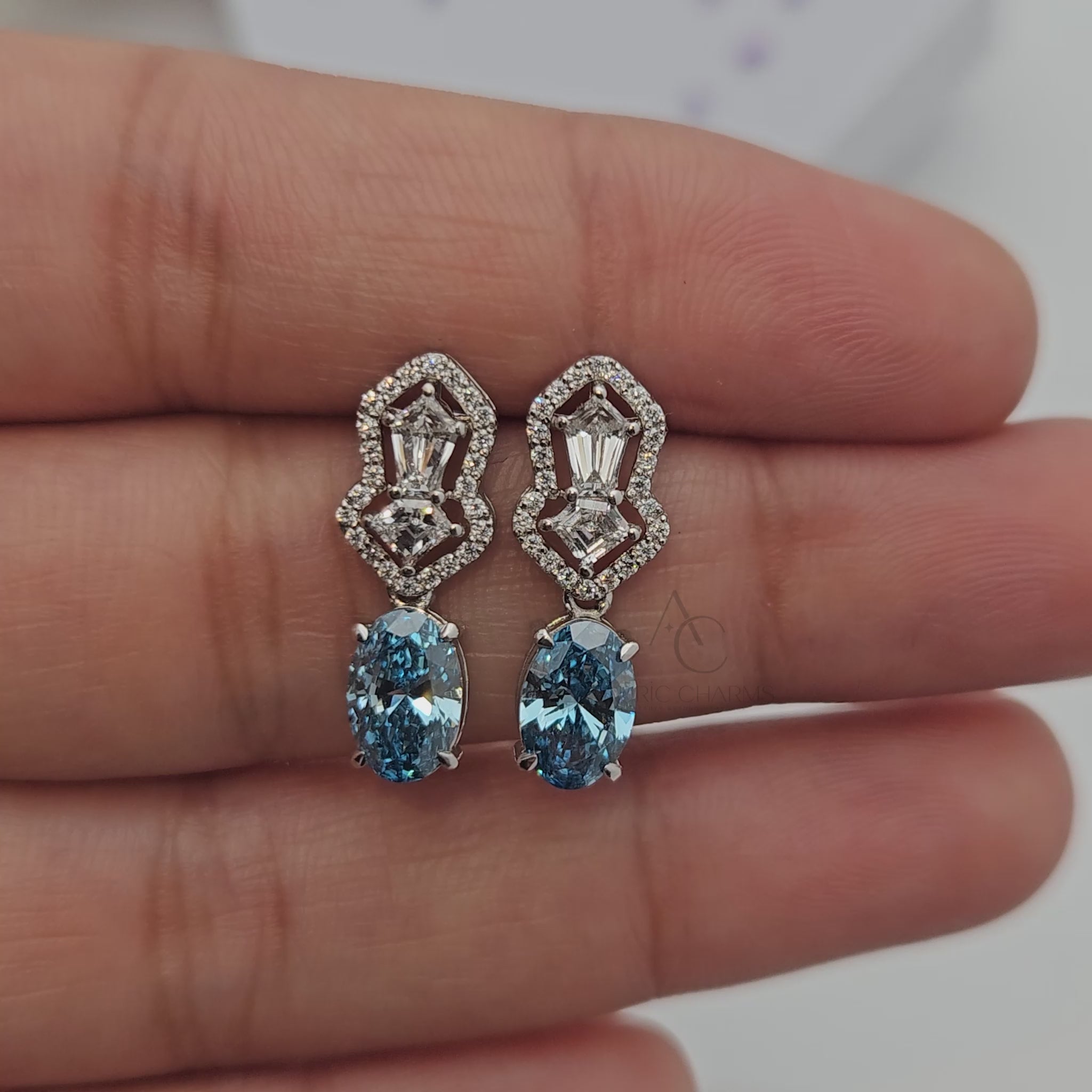Video featuring diamond and blue gemstone earrings with multiple angles and close-ups.