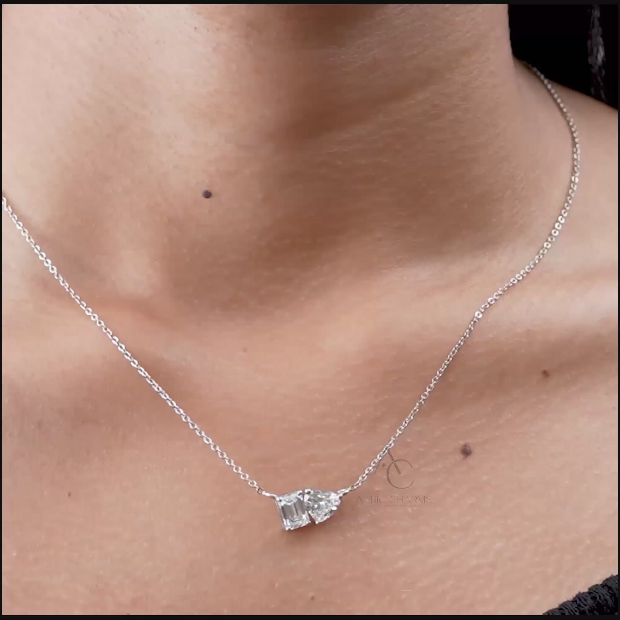 Luxury Lab Grown Diamond Toi et Moi pendant in Emerald and Heart cut, elegantly worn on neck, showcasing sustainable elegance.