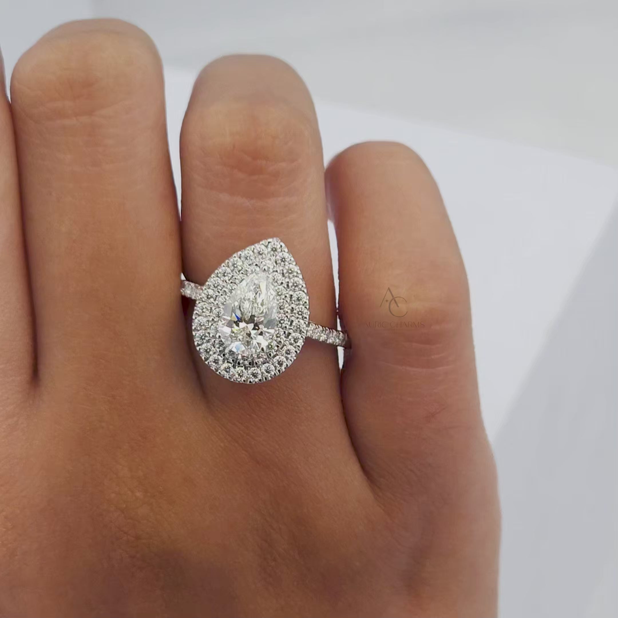 360-degree video of a pear-shaped diamond ring with a double halo and diamond band.