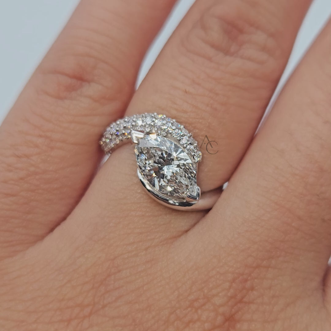 Pear-shaped diamond ring with curved diamond band shown from multiple angles.