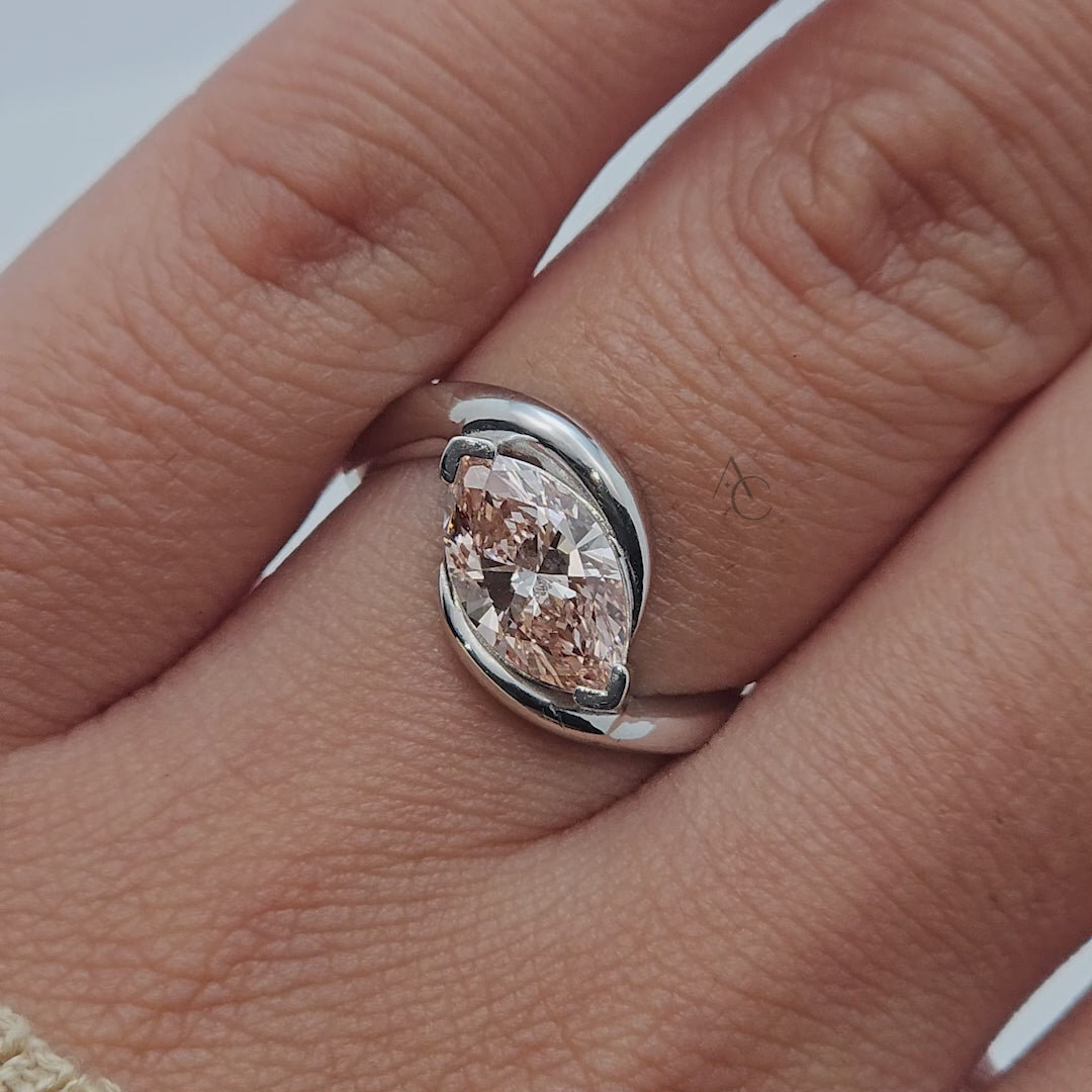 Marquise-cut pink diamond bypass ring in white gold, rotating to show all angles.