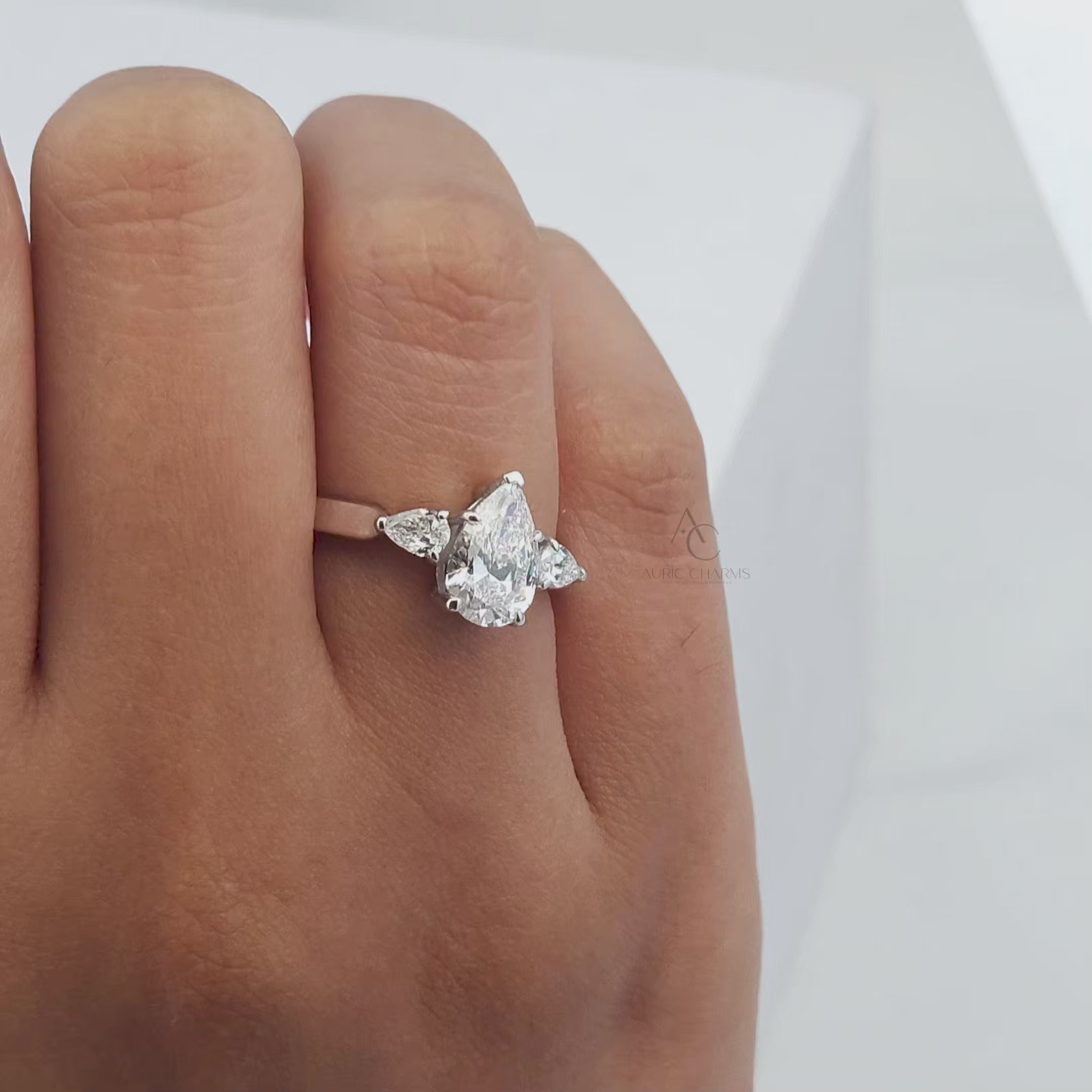 360-degree video of a pear-cut diamond ring with platinum band, capturing brilliance and fine details